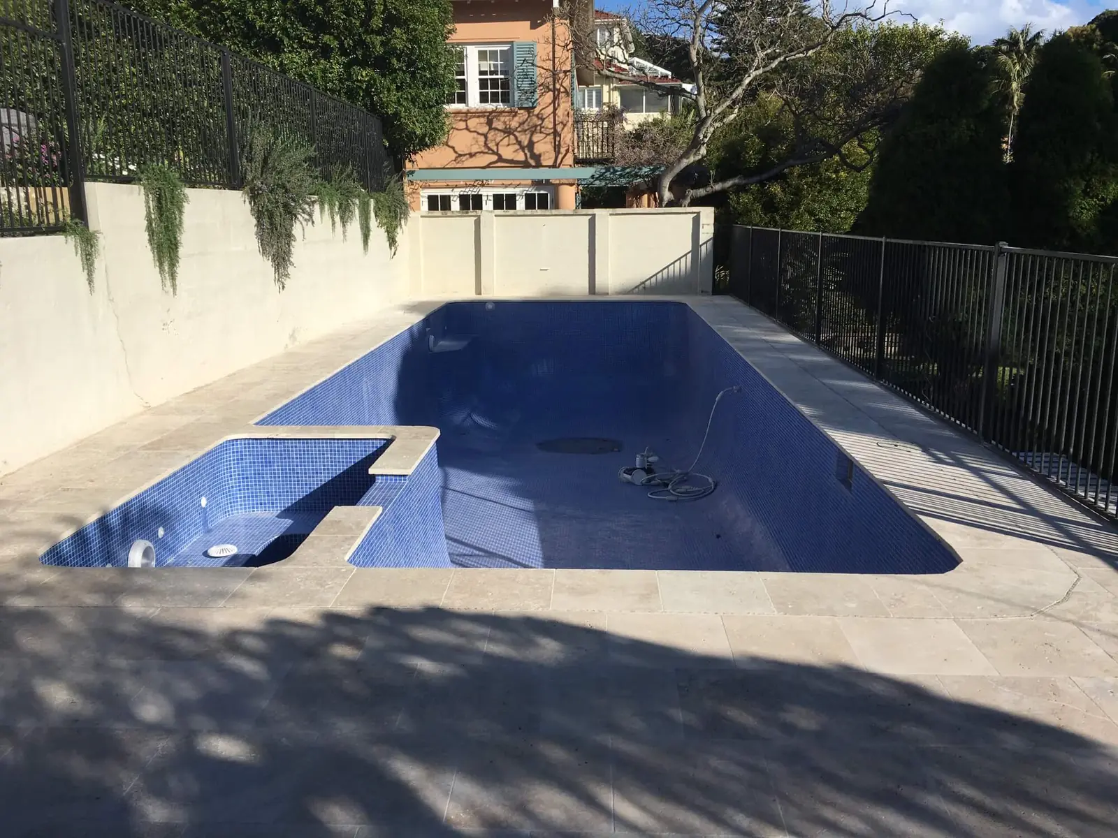 Long pool with attached spa and sandstone surrounds