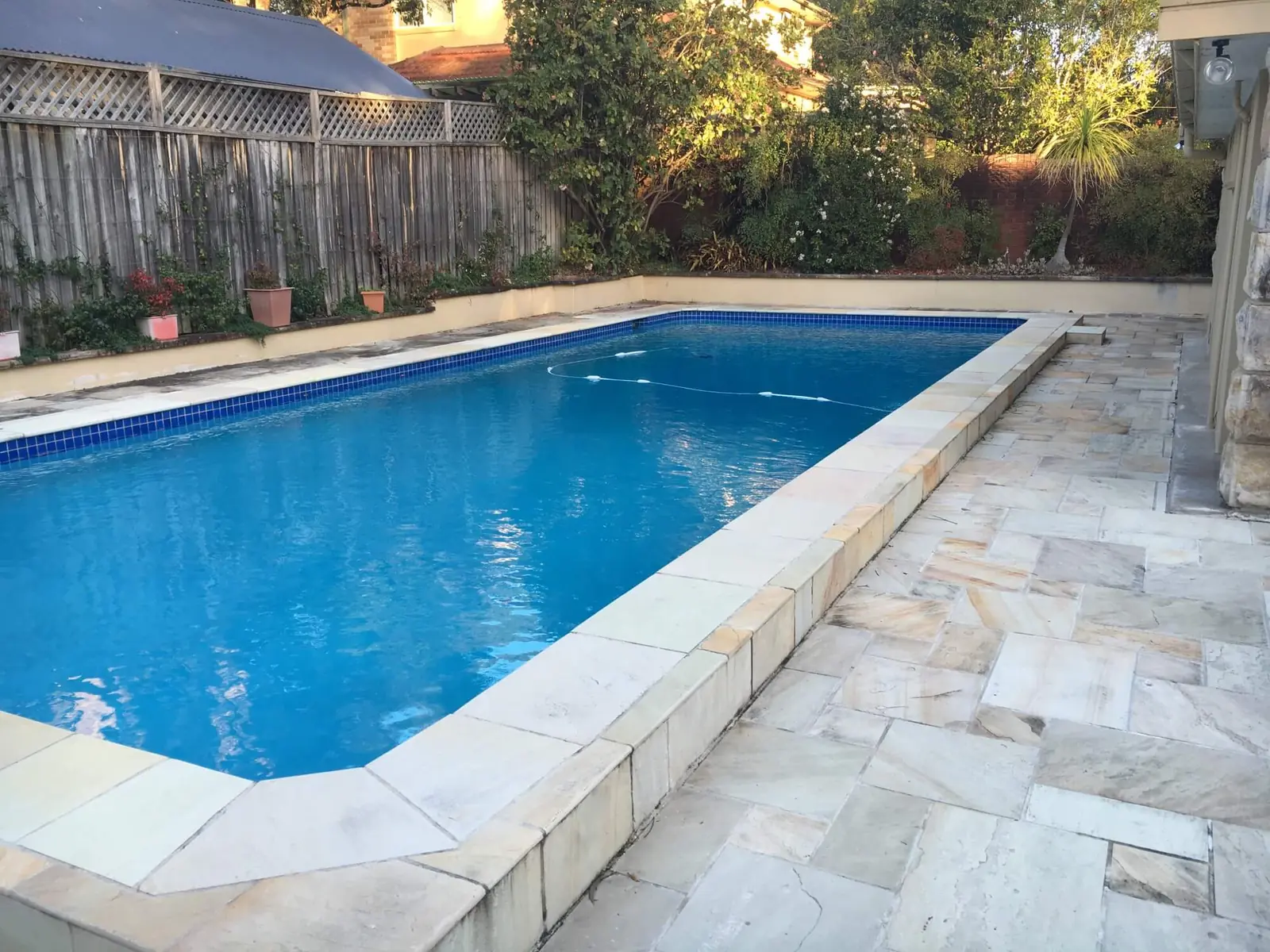 Rectangular pool with sandstone coping and paving